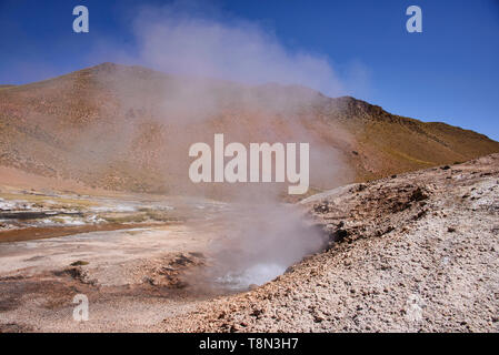 Watching a geyser erupt along the Rio Blanco, El Tatio, San Pedro de Atacama, Chile Stock Photo