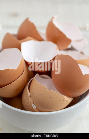 A white bowl full of broken egg shells. Stock Photo