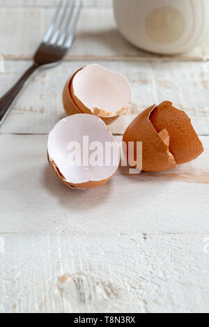 Broken egg shells on a kitchen table. Stock Photo