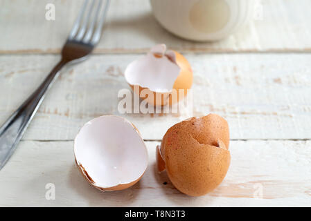 Broken egg shells on a kitchen table. Stock Photo