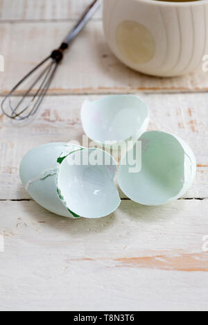 Broken blue egg shells on a kitchen table. Stock Photo