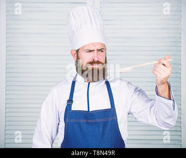 Preparation of food. Healthy food cooking. Bearded man cook in kitchen, culinary. Chef man in hat. Secret taste recipe. Dieting and organic food, vitamin. Vegetarian. Mature chef with beard. Stock Photo