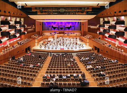 Interior of the Royal Festival Hall on London's South Bank (opened in 1951. Stage prepared for orchestra, audience entering for a classical concert. Stock Photo