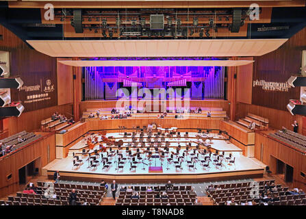 Interior of the Royal Festival Hall on London's South Bank (opened in 1951. Stage prepared for orchestra, audience entering for a classical concert. Stock Photo