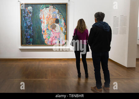 Leopold Museum Vienna, rear view of two people looking at Death And Life (Tod Und Leben) by Gustav Klimt inside the Leopold Museum in Vienna, Austria. Stock Photo
