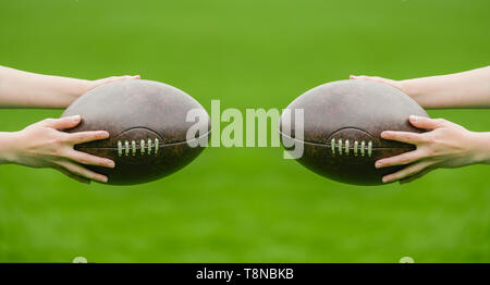 A woman holds a rugby ball, isolated on a green background Stock Photo