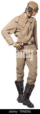 A uniform ensemble for a pilot, summer outfit Summer flight helmet with larynx microphone, aviator goggles with tieback. Summer combination with 'Ri-Ri' zip closures and 'Prym' buttons, arm compass, brown leather belt with aluminium buckle and pistol holster. Lined leather boots with lateral zip closures and heating connections. The uniform is mounted on a movable mannequin with a martial profile. All parts with light signs of wear, mostly with maker or requisition markings. A beautiful ensemble for a typical aviator's summer outfit. historic, historical, Air Force, branch , Editorial-Use-Only Stock Photo