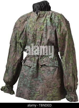 A lace-up shirt in oak branches camouflage Cloth imprinted on both sides, reversible spring/autumn colours. A heavily used piece with heavy damages due to age (tears, losses). historic, historical, 20th century, 1930s, 1940s, Waffen-SS, armed division of the SS, armed service, armed services, NS, National Socialism, Nazism, Third Reich, German Reich, Germany, military, militaria, utensil, piece of equipment, utensils, object, objects, stills, clipping, clippings, cut out, cut-out, cut-outs, fascism, fascistic, National Socialist, Nazi, Nazi period, Editorial-Use-Only Stock Photo