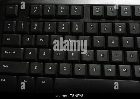 Close up of QWERTY keys along with function keys on black keyboard Stock Photo
