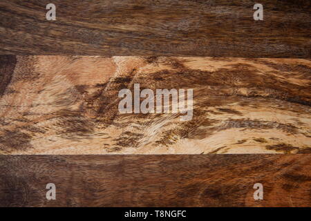 The contrasting pattern of wood on a wooden board from mango tree. The texture of the mango tree - image Stock Photo