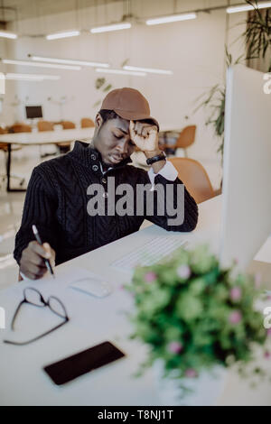 Stress, fatigue overwork. Tired African American employee in formal wear holding eyeglasses, rubbing his eyes and massaging nose bridge to release ten Stock Photo