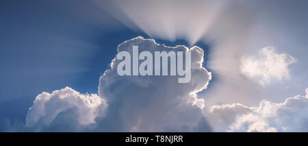 Sun shining through the heavenly beautiful clouds in the sky Stock Photo