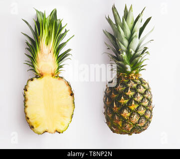 Whole and half pineapple on white Stock Photo