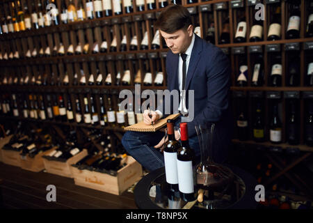 young man giving advice about wine. close up photo. Stock Photo