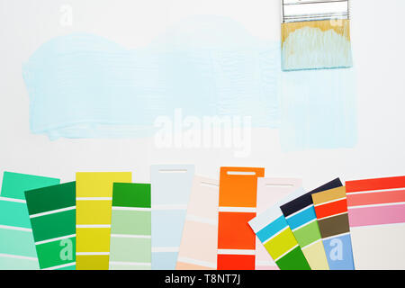 Picture of palette with blue and green, red colors, brush, on blank white background. Stock Photo
