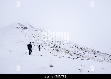 Two climbers is going to the summit in a snow mountain. Stock Photo