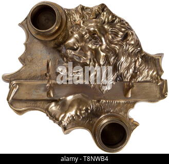An Imperial German presentation ink well to Oberst Paul von Lettow-Vorbeck Brass with a three-dimensional lion design. Measures 29 x 26 cm. Two removable brass ink containers and holder for two pens in the form of two antlers mounted on a scroll. Scroll is engraved 'Dem Löwen von Ostafrika / unserem Kommandeur / Oberst Paul von Lettow-Vorbeck 4. Nov. 1916.' His small force of 14,000 kept 300,000 British busy for the war. USA-lot, see page 5. historic, historical, navy, naval forces, military, militaria, branch of service, branches of service, arm, Additional-Rights-Clearance-Info-Not-Available Stock Photo