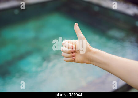 Hand shows like. Pool quality, pool cleaning Stock Photo