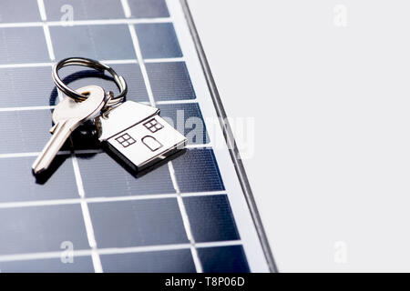 A solar panel with house key. Eco house new home concept Stock Photo