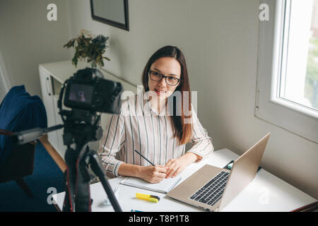 Girl blogger records video for their subscribers. Infobusiness or information business or hobby or online training or education for people. Stock Photo