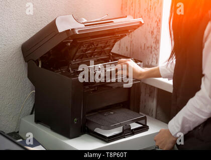 office worker change the cartridge in a laser printer Stock Photo