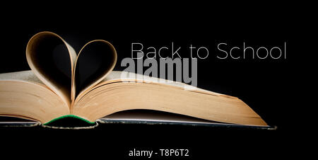 Back to school. Book sheets folded into a heart shape. Text. Love education, concept Stock Photo