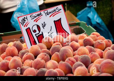 Peaches on a market stall Stock Photo