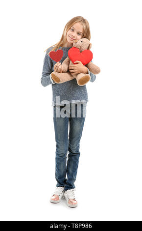 Cute little girl with red heart and teddy bear on white background Stock Photo