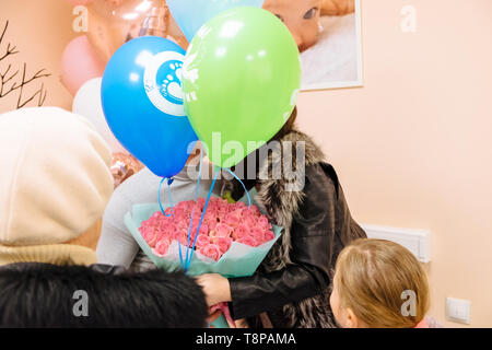 Happy father and mother are being discharged from parental home. Discharge from maternity hospital Stock Photo