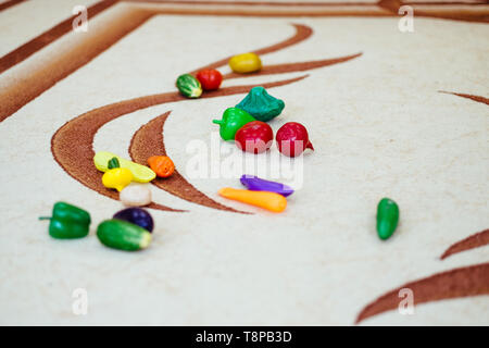 children's toys from vegetables scattered on the carpet Stock Photo