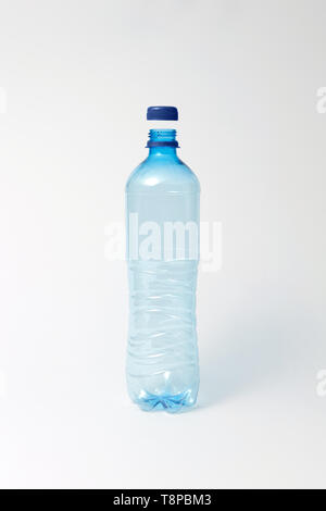 Blue transparent bottle for water on a light background. Mock up. Stock Photo