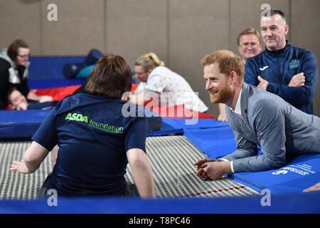 Britain's Prince Harry, Duke of Sussex interacts with a participant of the Rebound Therapy session as he visits the OXSRAD Disability Sports and Leisure Centre, in Oxford, southern England on May 14, 2019, during a visit to highlight positive work underway in the area to support the needs of children, young people and adults. (Photo by Daniel LEAL-OLIVAS / various sources / AFP) Stock Photo