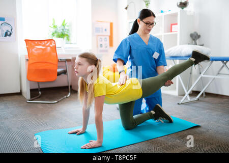 Calm blonde girl wearing comfortable clothes during appointment Stock Photo