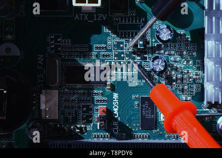 Close up needle tipped tip multimeter checking service  repairing cpu computer. Repairing and service concept Stock Photo
