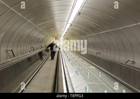 Quebec,Caanada. A man going down an escalator at the Beaudry subway station in Montreal Stock Photo