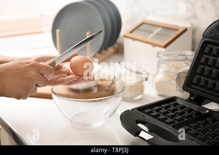 Woman making dough for waffles in kitchen Stock Photo