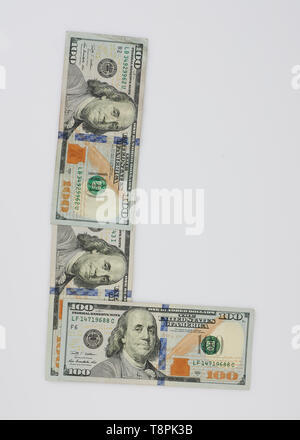 L letter made from dollar bill isolated on white background Stock Photo