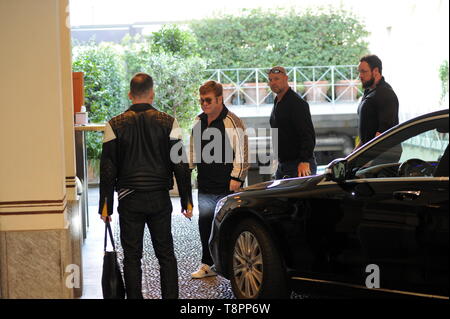 Milan, Elton John and husband David Furnish shopping in the center Elton John arrives downtown with her husband David Furnish escorted by 3 bodyguards, and after getting out of the car she enters from 'HERMES', a prestigious boutique in Via Montenapoleone. As soon as he notices the presence of the photographers, he lets himself go to an eloquent gesture, showing his middle finger, and hides in a closed room so as not to be taken up again. When he leaves, he immediately enters the car, parked just two meters away, and heads for the hotel and then permanently goes upstairs to the suite with her Stock Photo