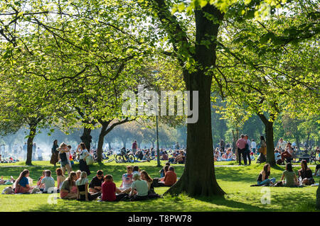 Edinburgh, Scotland, UK. 14 May 2019. Warm sunny weather in the capital brought hundreds of people to The Meadows park in the afternoon to enjoy the sun. The park is adjacent to Edinburgh University and it seemed that most of the crowd were students taking a break from studying for upcoming exams Credit: Iain Masterton/Alamy Live News Stock Photo