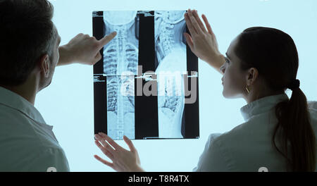 Two doctors discussing patients x-ray and MRI scans, chest x-rays Stock Photo