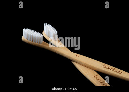 Pair of Bamboo tooth brushes on a black background. Eco friendly hygiene product. Stock Photo