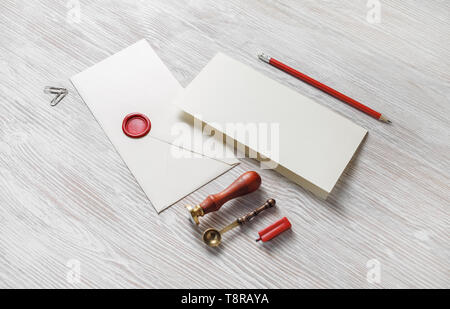 Vintage envelope and stationery on light wooden background. Responsive design mockup. Stock Photo