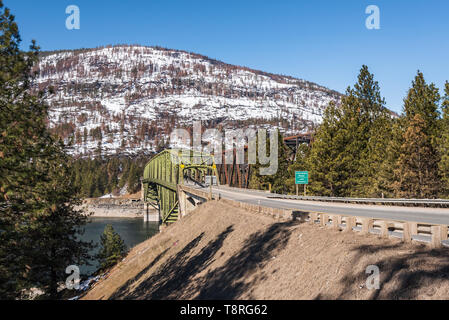 State Highway 20, US Highway 395 and the railroad cross Lake Roosevelt at Kettle Falls, Washington on Steel Truss Bridges in the early spring Stock Photo