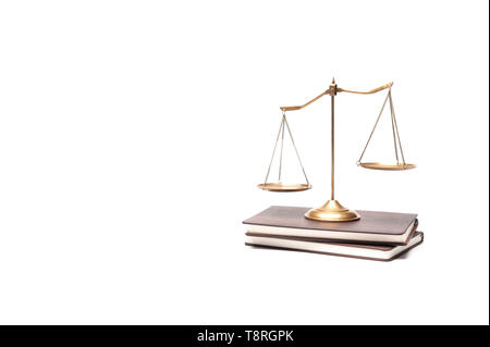 Gold brass balance scale placed on the vintage books isolated on white background, legal law concept. Sign of justice, lawyer Stock Photo