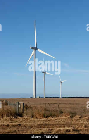 Three wind turbines on a farm in the Australian countryside. Stock Photo
