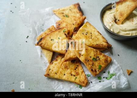 Homemade Lavash  Pita Chips served with Hummus, selective focus Stock Photo