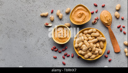 Bowls with peanut butter and peanuts Stock Photo