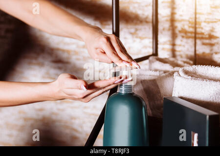 Female applying moisturizer lotion, body cream after bath. Skincare, body care, beauty products concept. Close up, healthy hands. Stock Photo