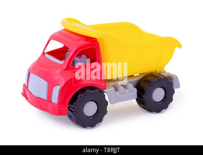 Vintage dump truck isolated on white background with shadow reflection. Plastic child toy on white backdrop. Dump tipper truck lorry construction vehi Stock Photo