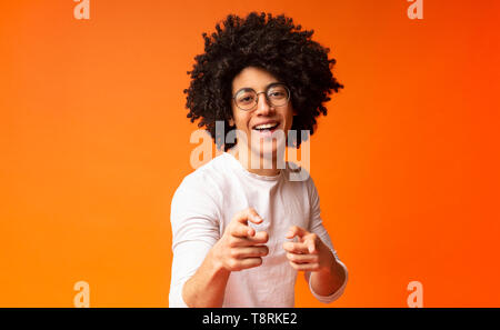 Flirty black man pointing at camera with both hands Stock Photo